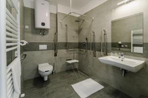a bathroom with a sink and a toilet and a shower at Airport Noa Panzió in Vecsés +32 photos