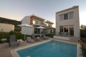 a villa with a swimming pool and a house at NAMARE AQUA in Skala Sotiros