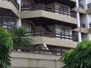 a building with balconies on the side of it at Locação Temporada - Condomínio Praia do Arpoador in Peruíbe