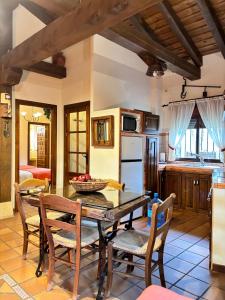 a kitchen and dining room with a table and chairs at Casa Rural Los Regajales in Tenzuela +37 photos