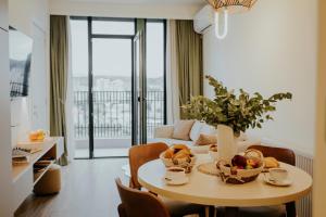 a kitchen and living room with a table with fruit on it at Pool House in Tbilisi City