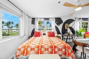 a bedroom with a large bed with red pillows at Beachfront Ocean View Apartment on Ocean Drive in Miami Beach +22 photos