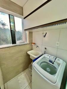 a small bathroom with a toilet and a sink at Apê Vumbora Pra Praia, todo climatizado, a 200 m da praia in Ilhéus