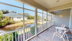a balcony with a table and chairs and a view of a river at Beach Bum Adventure 2 Bdrm 2 Bath Scenic View in Pawleys Island