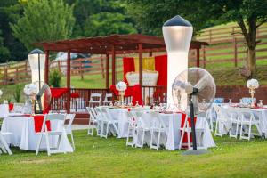 a group of tables with white chairs and a gazebo at Country Cove in Brentwood