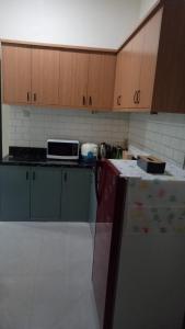 a kitchen with a counter top and a microwave at Taman Salak Homestay -5BR Entire House in Madiun
