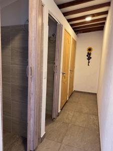 an empty hallway with two doors and a walk way at Casa Rionegro Colonial in Rionegro