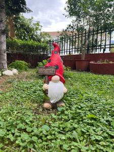 a toy chicken is standing in the grass at Veronika house Under Meteora in Sarakína