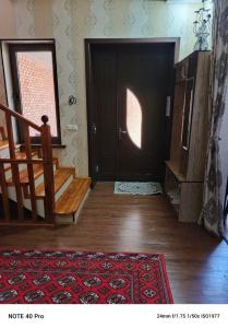 a room with a black door and stairs and a rug at Chaqar in Tashkent +34 photos