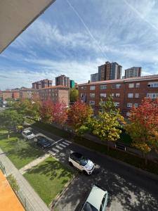 a view of a city with cars parked in a parking lot at Apartamento en Santander in Santander