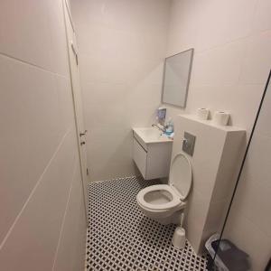 a small bathroom with a toilet and a sink at Ryo 18 דירה במלון בוטיק 2 דקות מטיילת בת ים in Bat Yam +16 photos