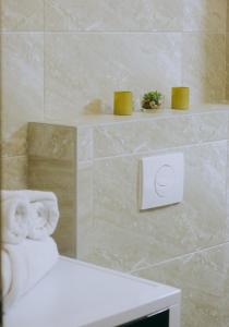 a bathroom with a white computer on a wall at Dina Lux Iasi Apartment in Iaşi