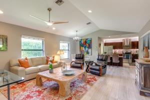 a living room with a couch and a table at Jupiter Cottage with Patio, Gas Grill and Fire Pit! in Jupiter