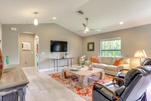 a living room with a couch and a table at Jupiter Cottage with Patio, Gas Grill and Fire Pit! in Jupiter