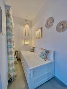 a small bedroom with a bed in a room at Kalimera Apartment in Kalymnos