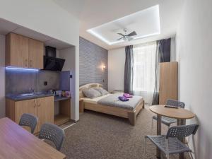 a bedroom with a bed and a table and chairs at 70s Guest room in Krakow