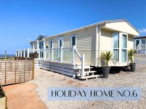 a holiday home with a sign that reads holiday home yes at Anchor's Drop in Blue Anchor +246 photos