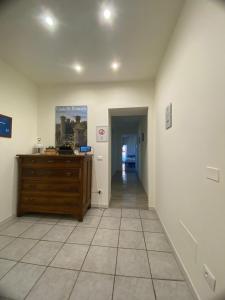 an empty hallway with a wooden dresser in a room at LA CHIUSA Bed and Breakfast in Montichiari