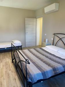 a bedroom with two beds and a closet at LA CHIUSA Bed and Breakfast in Montichiari +9 photos
