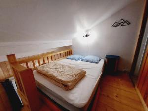 a small bed in a room with at LE COSY à Aime La Plagne in Aime-La Plagne