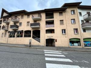 a large building on the side of a street at LE COSY à Aime La Plagne in Aime-La Plagne