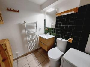 a bathroom with a white toilet and a sink at LE COSY à Aime La Plagne in Aime-La Plagne +13 photos