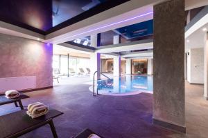 a lobby with a swimming pool in a building at Hotel Zum Löwen - Al Leone in Meltina