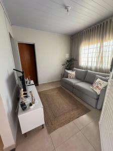 a living room with a couch and a table at Cantinho do Sossego in Uberlândia