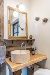 a bathroom with a sink and a mirror at Aslundur Lakefront Villa in Vaðlækir