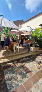 a group of people sitting at a table under umbrellas at Yolo Hostel Medellin in Medellín +187 photos