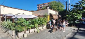 a group of people standing outside of a restaurant at Yolo Hostel Medellin in Medellín