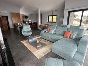a living room with a blue couch and a table at Miramar in Angra do Heroísmo