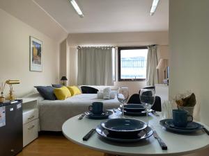 a room with a bed and a table with plates on it at Nido del Cormorán in Ushuaia