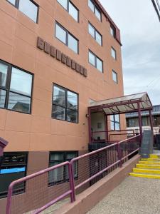 a building with a staircase next to a building at Nido del Cormorán in Ushuaia