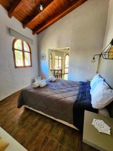 a bedroom with a large bed in a room at El Torreón Lodge in Potrerillos