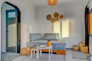 a living room with a bed and a table at Muse in Zaouit Louda
