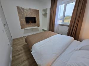 Ένα ή περισσότερα κρεβάτια σε δωμάτιο στο SaGa Apartament