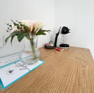 a vase of flowers sitting on top of a table at Costa by Hawkins Algeciras - Exterior 2A in Algeciras