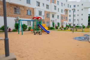 a playground in front of a building with a slide at LTM Stays ,Buxton Point , Mombasa in Mombasa