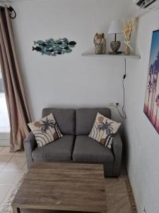 a living room with a couch and a table at MARINA ILE DES PECHEURS in Le Barcarès +18 photos