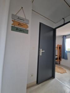 a room with a door and a sign that reads graduation at MARINA ILE DES PECHEURS in Le Barcarès
