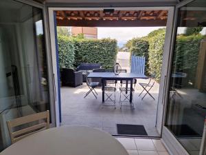 a view of a patio with a table and chairs at MARINA ILE DES PECHEURS in Le Barcarès
