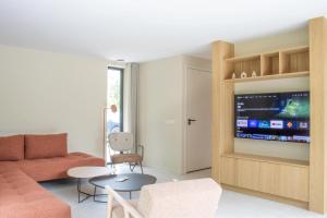 a living room with a couch and a tv at Mids in Midsland