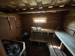 an empty wooden sauna with a bench and a window at Rõtu saunamaja in Leeskopa