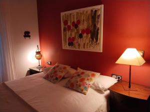 a bedroom with a bed with white sheets and pillows at Gure Idorpea in Lesaka