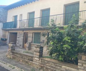 a brick house with a balcony and a fence at Chez Douddine in Pont-du-Château
