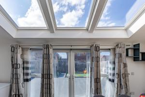 a skylight in a living room with windows at Luxurious 2 Bed House near Birmingham in Bilston