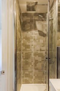 a shower with a glass door in a bathroom at Luxurious 2 Bed House near Birmingham in Bilston +15 photos