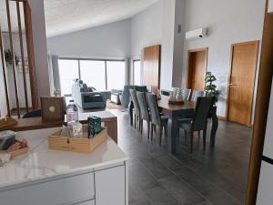 a kitchen and dining room with a table and chairs at Miramar in Angra do Heroísmo +27 photos