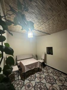 a room with a table and chairs and a ceiling at Stylish Moroccan appartement in Marrakech +14 photos